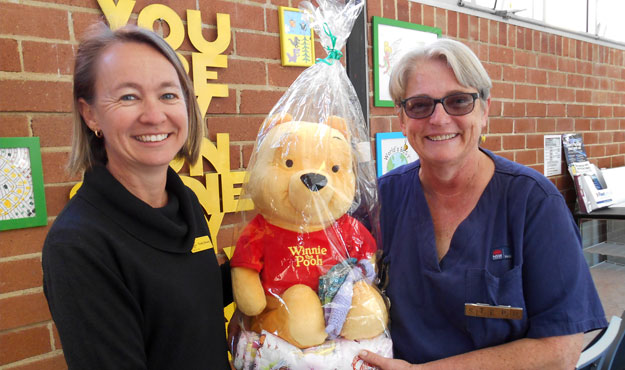 Stephanie SStephanie Smith, Justice Health at Silverwater Women's Correctional Centre being presented with her prize by Wendy Barnert, Finance Manager, SHINE for Kids" or something of that nature.mith is 